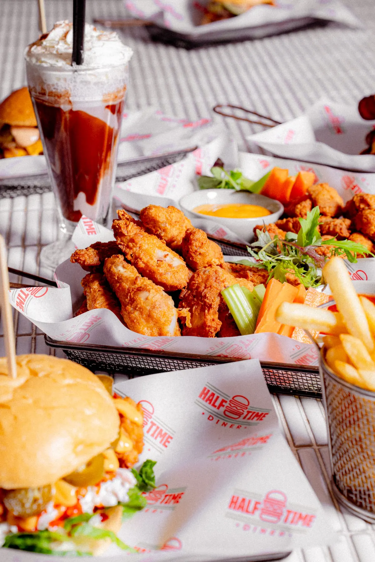 Chicken tenders, fries and a burger with a shake