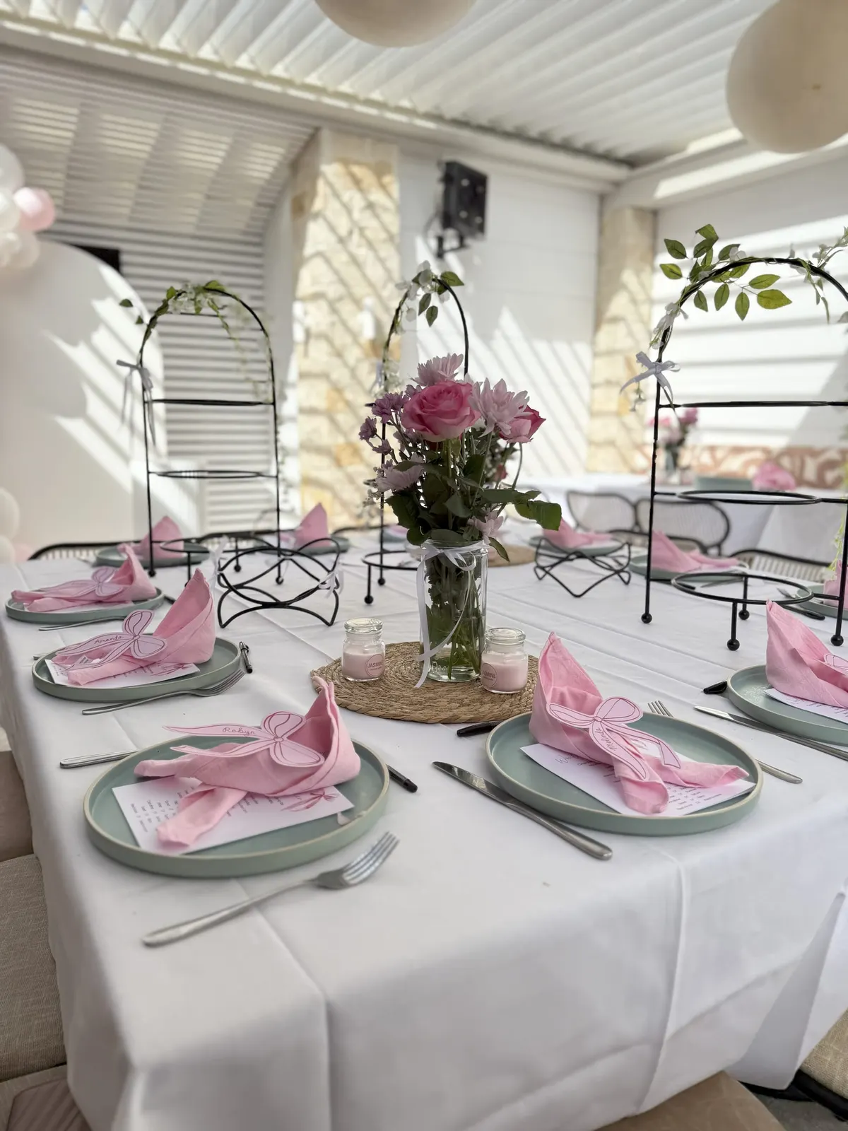 Function table styled with pink napkins, flowers and candles