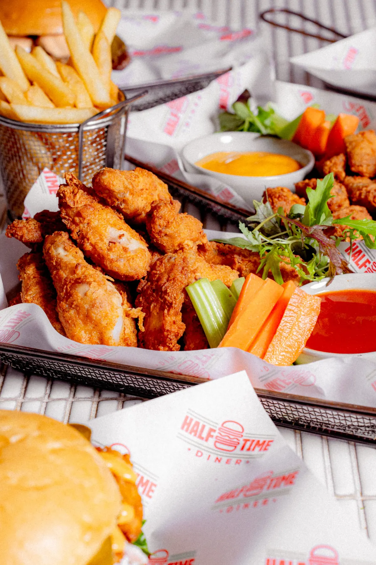 Basket of fried chicken with dipping sauce and fries