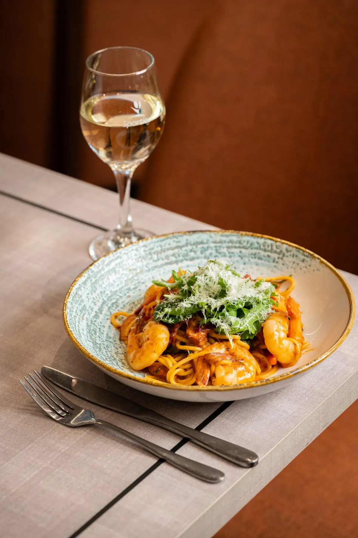 Prawn spaghetti under rocket and shaved parmesan