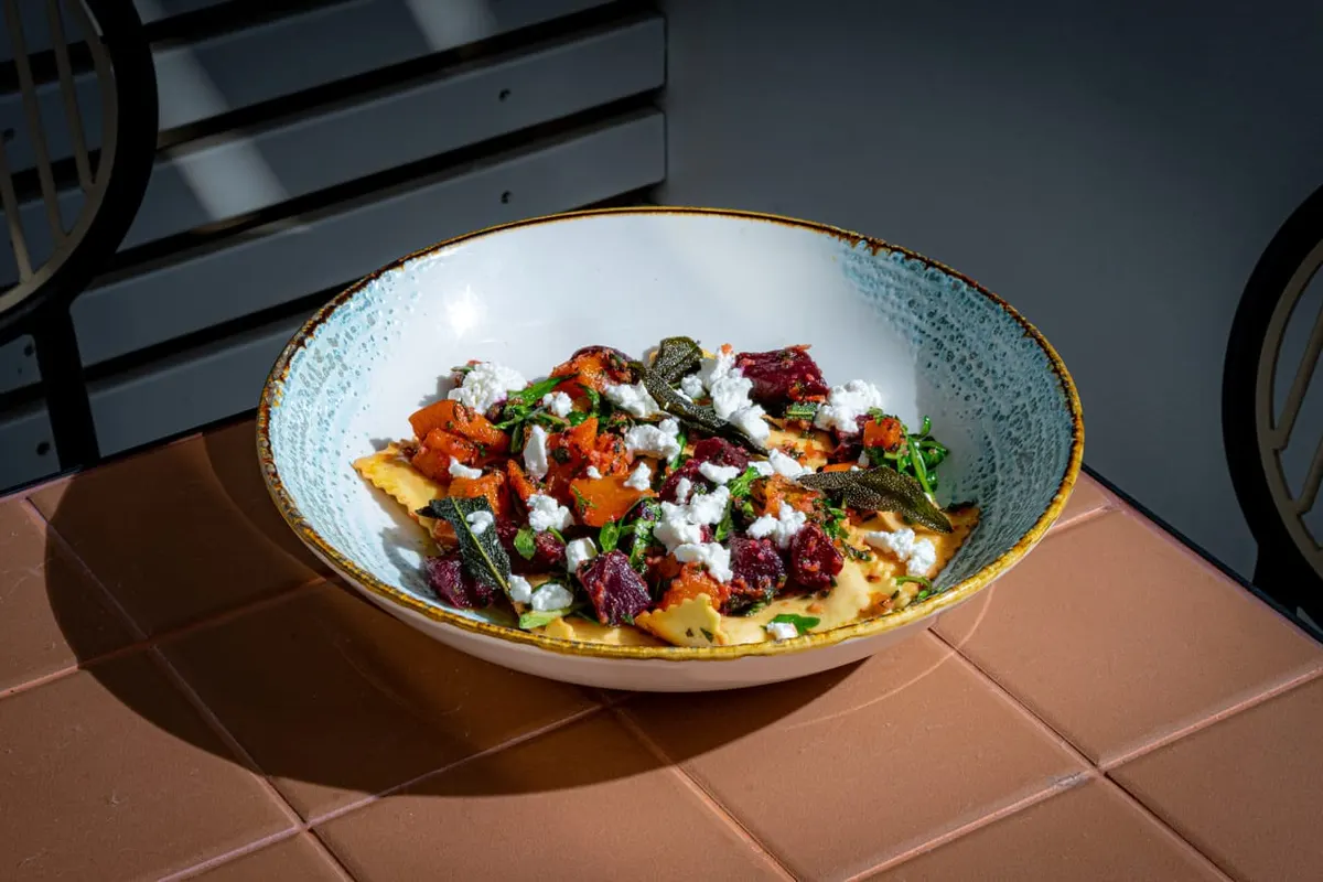 Roasted pumpkin and beetroot salad in a ceramic bowl