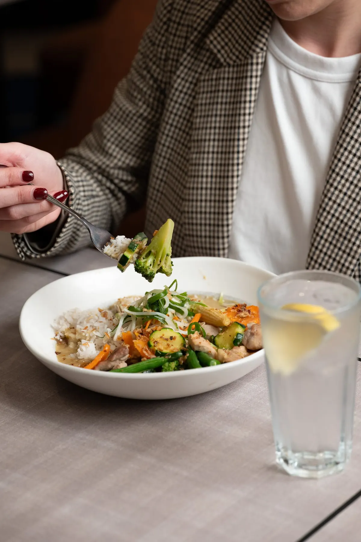 Guest enjoying a fresh rice bowl with sparkling water