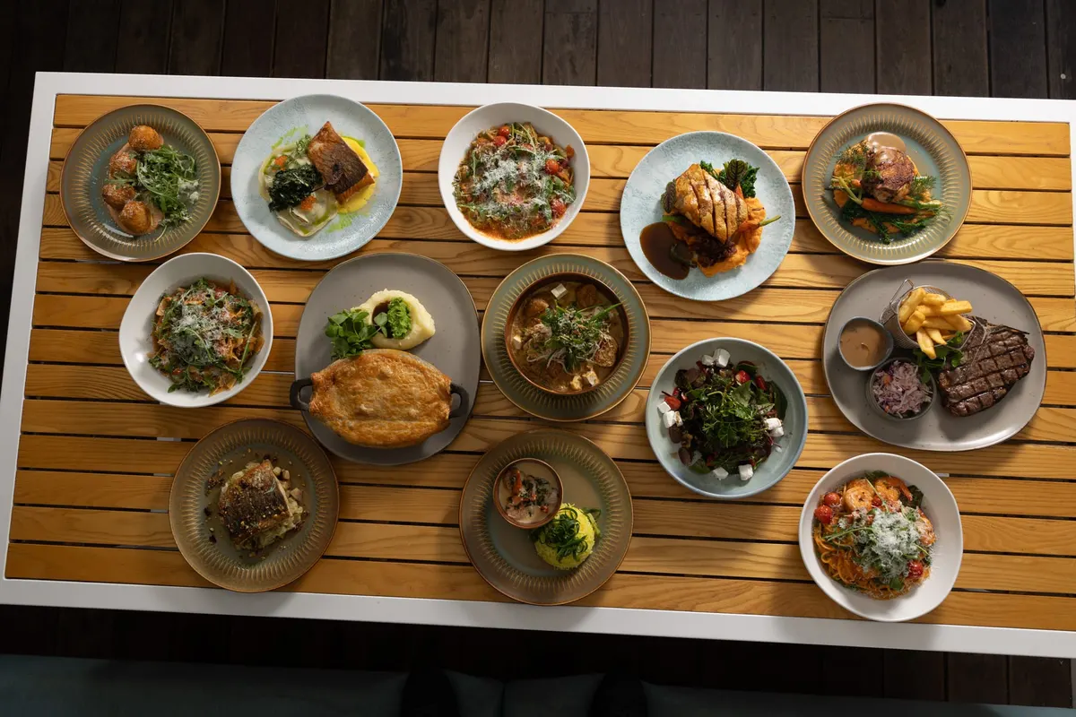 Banquet table filled with shared plates, seen from above