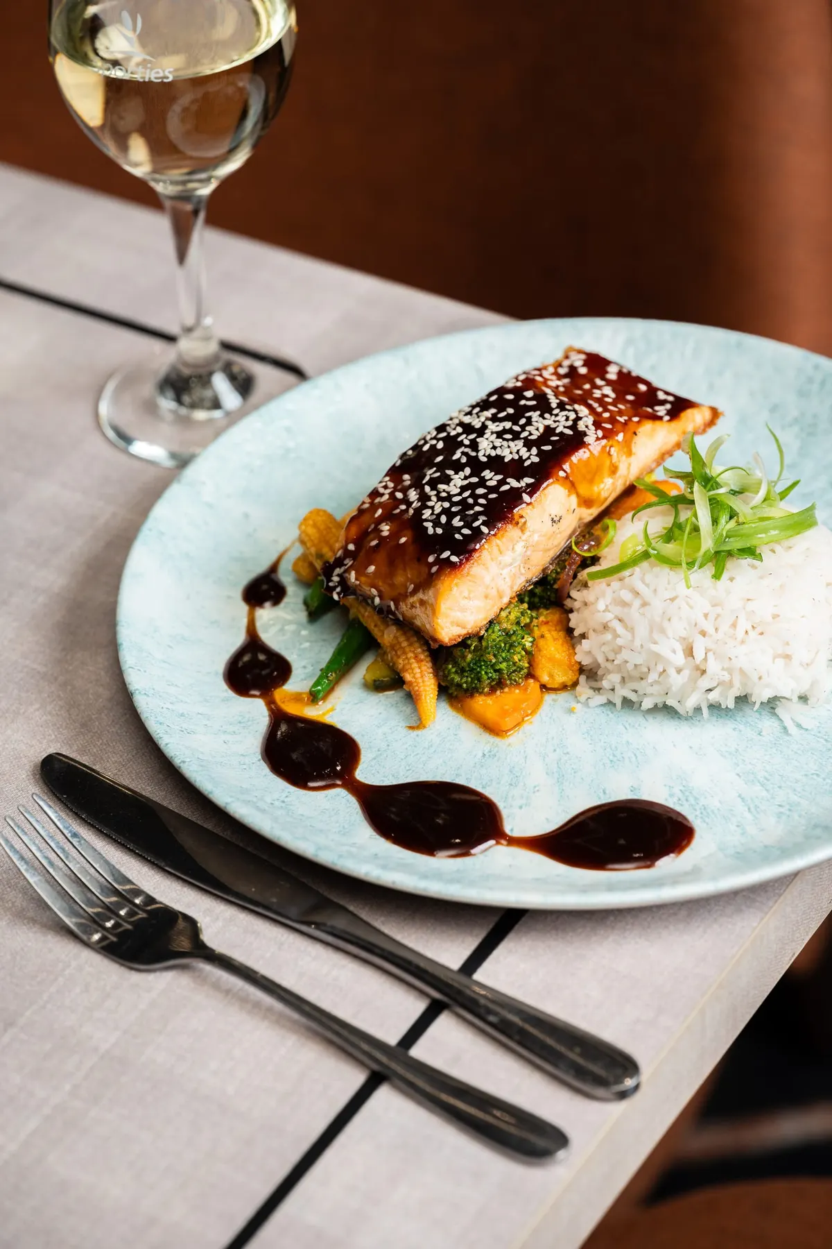 Sesame-glazed salmon with steamed rice and vegetables