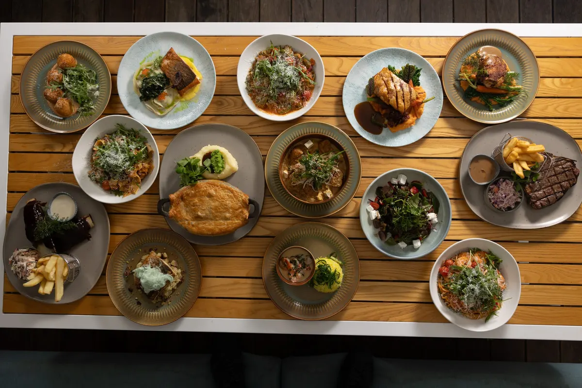 A long function table of shared plates seen from above